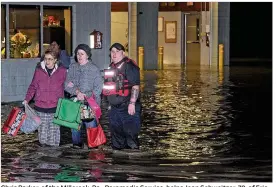  ?? CHRISTOPHE­R MILLETTE / ERIE TIMES-NEWS ?? Chris Parker, of the Millcreek, Pa., Paramedic Service, helps Jean Schweitzer, 79, of Erie (left) and her daughter Betsy Yochim, 55, of Harborcree­k Township out of the Belle Valley Fire Department in Erie County on Sunday following flooding. About 100...