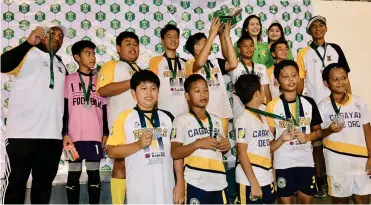  ?? (Sun*Star photo by Jack Biantan) ?? RUNNER-UP. Region X team B players and coaches display their runner-up trophy and silver medals during the awarding ceremony in the 15th Thirsty Football Cup Festival at the Cebu City Sports Center.