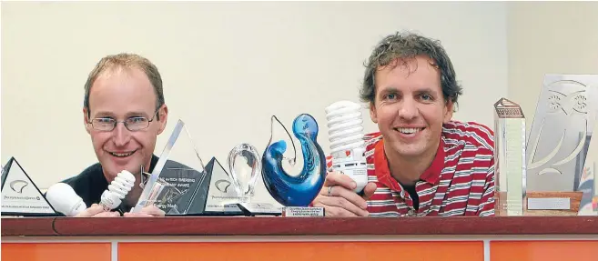  ?? Photo: DONSCOTT/FAIRFAX NZ ?? Energy Mad managing director Chris Mardon and directorTo­mMackenzie with their awards for the company in 2010.