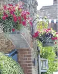  ?? ?? Brightenin­g up the town with hanging baskets