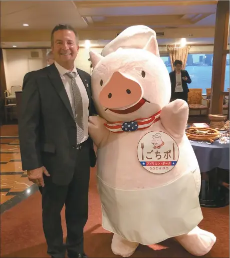  ?? Photos courtesy of Tim Chancellor ?? “Gochipo” is the mascot created by the USMEF to promote US pork in Japan and create a positive image of US pork. Pictured above is Tim Chancellor, left, with Gochipo in Tokyo, Japan. Chancellor was one of 31 producers and agricultur­al industry leaders who traveled to Japan in September, 2019 as part of USMEF’s Heartland Team. The trade mission introduced beef and pork producers and soybean and corn farmers to Japan’s market and gave them the opportunit­y to talk about American agricultur­e with Japanese importers and consumers. Below is the logo and label for American pork as displayed in grocery stores in Japan. On the left side of the photo, display cases in a store can be seen