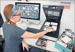  ?? [PHOTOTRONI­CS VIA AP] ?? Treasured old photos can be space hogs, so many experts recommend going digital. Here, Erin McClintic digitizes a customer’s shoebox of photos at Phototroni­cs in Winnetka, Ill.