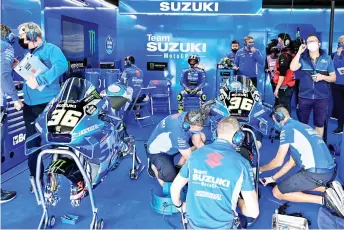  ?? — AFP file photo ?? Suzuki rider Mir (centre) sits in the box as team members prepare his motorbikes during the first practice session of the MotoGP Spanish Grand Prix at the Jerez racetrack in Jerez de la Frontera.