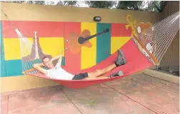  ??  ?? Andreas Chavanne of Basel, Switzerlan­d, relaxing in the courtyard at Reggae Hostel in Ocho Rios, St Ann.