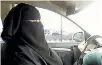  ?? PHOTO: REUTERS ?? Umm Ibrahim sits behind the wheel of her vehicle as she drives in Riyadh.