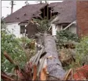  ?? The Canadian Press ?? A home shows a hole where a tree fell into it during a tornado in Ottawa.