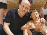  ?? (Courtesy) ?? PRIME MINISTER Naftali Bennett and his son, David, take a rest during their family hike in the Peres River basin in the Judean Desert yesterday.