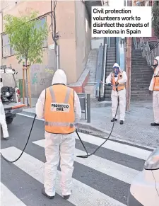  ??  ?? Civil protection volunteers work to disinfect the streets of Barcelona in Spain