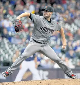  ??  ?? The Diamondbac­ks’ Robbie Ray pitches in the first inning.