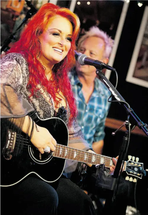  ?? ERIKA GOLDRING/ GETTY IMAGES ?? Wynonna Judd performs a special acoustic show at Bluebird Cafe on June 3, 2013 in Nashville, Tenn. Her husband Cactus Moser is in the background.