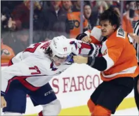  ?? DERIK HAMILTON — THE ASSOCIATED PRESS ?? Washington’s T.J. Oshie, the third period Sunday. left, fights the Flyers’ Travis Konecny during