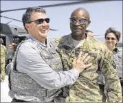  ?? GLENN FAWCETT / DEPARTMENT OF DEFENSE ?? In this 2013 photo provided by the Department of Defense, then-U.S. Army Brig. Gen. Ron Lewis (right) greets thenDeputy Secretary of Defense Ash Carter in Afghanista­n.