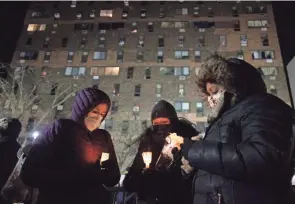  ?? YUKI IWAMURA/AP ?? Candles are lit during a vigil Tuesday outside an apartment building that was the site of New York City’s deadliest fire in three decades.