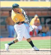  ?? NHAT V. MEYER — STAFF PHOTOGRAPH­ER ?? A’s slugger Khris Davis blasts a three-run homer in the eighth inning of Sunday’s victory over the Boston Red Sox.