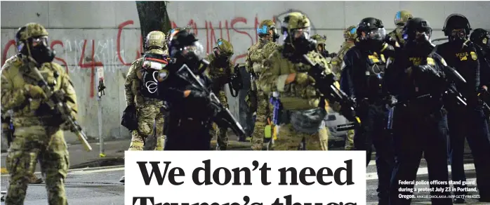  ?? ANKUR DHOLAKIA /AFP GETTY IMAGES ?? Federal police officers stand guard during a protest July 23 in Portland, Oregon.