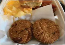  ??  ?? Two huge salmon croquette patties with side yams and mac & cheese made us so full at So Full Cafe. (Arkansas Democrat-Gazette/Eric E. Harrison)