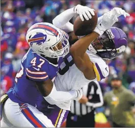  ?? Joshua Bessex Associated Press ?? VIKINGS WIDE RECEIVER Justin Jefferson, who had 10 catches for 193 yards and a touchdown, is brought down by Bills cornerback Christian Benford.