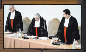  ?? Andrew Medichini
The Associated Press ?? Vatican tribunal president Giuseppe Pignatone reads the verdict of a trial against Cardinal Angelo Becciu and nine other defendants in the Vatican press room Saturday.