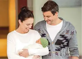  ?? EPA PIC ?? New Zealand Prime Minister Jacinda Ardern holding her newborn daughter next to her partner, Clarke Gayford, in Auckland yesterday.