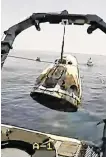  ??  ?? The SpaceX capsule is lifted on to the recovery vessel