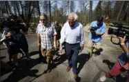  ?? RICH PEDRONCELL­I ?? FILE - In this Aug. 22, 2019, file photo, Democratic presidenti­al candidate Sen. Bernie Sanders, I-Vt., right, talks with area resident Michael Ranney, left, as he tours a mobile home park that was destroyed by last year’s wildfire in Paradise, Calif. Three Democrats in their 70s are vying to challenge the oldest first-term president in U.S. history. But science says age isn’t a proxy for fitness. The bigger question is how healthy you are and how well you function. With only a few years separating them, President Donald Trump at 73has mocked former Vice President Joe Biden, 76. Biden and Sanders, 77, try to showcase physical activity on the campaign trial while 70-year-old Elizabeth Warren even jogs around at rallies.
