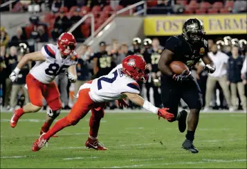  ?? ASSOCIATED PRESS PHOTOS ?? PURDUE RUNNING BACK D.J. KNOX (RIGHT) RUNS PAST Arizona cornerback Lorenzo Burns (2) for a touchdown during the first half of the Foster Farms Bowl on Wednesday in Santa Clara, Calif.