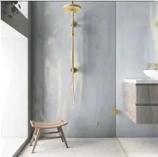  ?? ?? A new generation of more assertive pastels, such as Amity Blue marble from Opustone, make a sophistica­ted canvas for gold fixtures and trim.