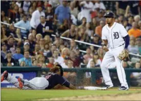  ?? PAUL SANCYA — ASSOCIATED PRESS ?? Jose Ramirez dives back into third base as Tigers third baseman Jeimer Candelario watches in the ninth inning June 8 in Detroit.