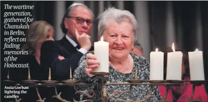  ?? PHOTO: GETTY IMAGES ?? Assia Gorban lighting the candles