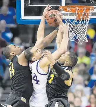  ?? David Eulitt Kansas City Star ?? A SHOCKING RESULT in Omaha left No. 2-seeded Kansas on the Midwest Regional scrap heap, eliminated by downstate rival Wichita State. Villanova and Virginia, Nos. 1-2 in East, are also out.