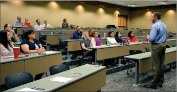  ?? Hunter McFerrin/Siloam Sunday ?? High school assistant principal Ross White led Wednesday’s meeting, and among other things, explained to educators and industry representa­tives what the high school’s ultimate goal is for their Career and Technical Education students.