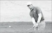  ?? Jeff Gross Getty Images ?? SEEKING his first career win, Hudson Swafford chips to the second green at the Nicklaus Course.