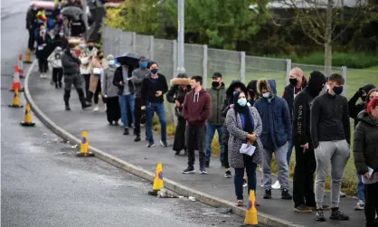  ??  ?? Members of the public queue to receive a Covid-19 vaccine at a temporary vaccinatio­n centre at the Essa academy in Bolton. Photograph: AFP/Getty