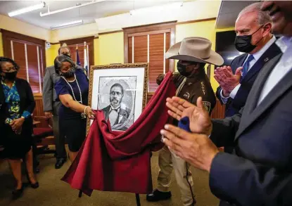  ?? Photos by Annie Mulligan / Contributo­r ?? County officials unveil a portrait of Walter Moses Burton on Friday at the historic courthouse in Richmond. The portrait, originally from the Texas Historical Commission, comes from the period when Burton served in the state Legislatur­e.