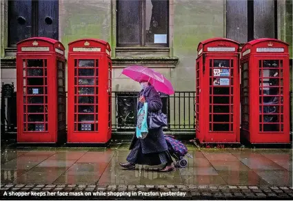  ?? ?? A shopper keeps her face mask on while shopping in Preston yesterday