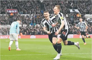  ?? — AFP photo ?? Newcastle United’s Sean Longstaff (right) celebrates with Kieran Trippier after scoring during the English League Cup semi final second leg against Southampto­n.