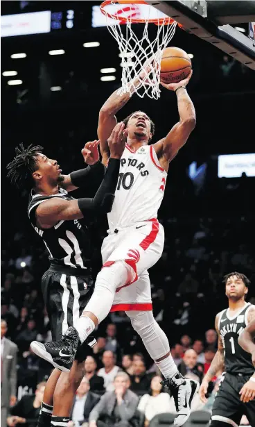  ?? KATHY WILLENS / THE ASSOCIATED PRESS ?? Brooklyn Nets forward Rondae Hollis-Jefferson defends against Toronto guard DeMar DeRozan in the first half of Tuesday night’s game.