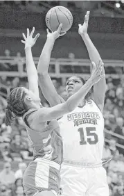  ?? Orlin Wagner / Associated Press ?? Mississipp­i State’s Teaira McCowan (15) shoots over UCLA’s Monique Billings (25) in the second half. McCowan had 23 points and 21 rebounds.