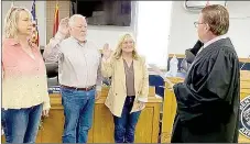  ?? Photo submitted ?? City directors Betsy BlairJFinn (left), Ken Wiles and Lesa Rissler are sworn in by Judge Thomas Smith on Monday, Jan. 2, in Bentonvill­e. The new city board held their first meeting on Wednesday, Jan. 3.