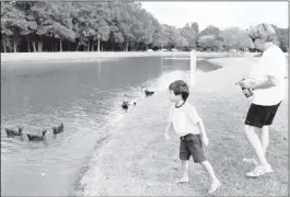  ?? BRAD VEST / THE COMMERCIAL APPEAL ?? Diane Pinson, from Colliervil­le, and her grandson, Jonah, 6, feed the ducks at one of the ponds in W.C. Johnson Park in Colliervil­le on Tuesday afternoon. “I walk here on the trails several times a week,” Pinson said.