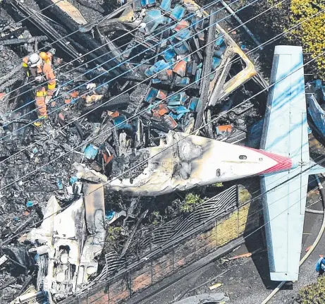  ?? Picture: AP ?? CHARRED REMAINS: The wreckage of the plane after crashing into homes in the suburbs of Tokyo yesterday,