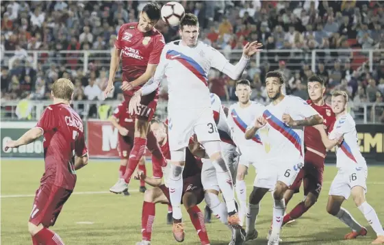  ??  ?? 2 Rangers’ Kyle Lafferty leaps alongside Ufa’s Vyacheslav Krotov during the hard-fought second leg of the Europa League play-off round tie at Neftyanik Stadium.