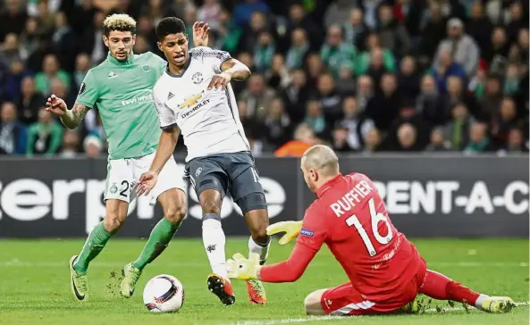  ?? — AP ?? Out of my way: Manchester United’s Marcus Rashford (centre) trying to get past St Etienne goalkeeper Stephane Ruffier in the Europa League last 32, second leg at the Geoffroy Guichard Stadium on Wednesday. United won 1- 0.