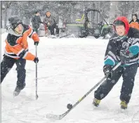  ?? ERIC MCCARTHY/JOURNAL PIONEER ?? Dillon Ellis (right) of the Cascumpec Rams knocks down a bounding puck during the P.E.I. Pond Hockey championsh­ip Saturday at Mill River Park. The Rams were named the most sportsmanl­ike of the 24 teams in the tournament.