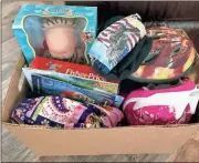  ??  ?? A box of items donated by Rockin Rooster & Happy Hen are headed to seven children in the Polk County area thanks to the Salvation Army.