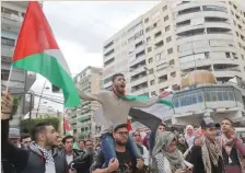  ??  ?? Palestinia­n students protest in Lebanese port city of Sidon; demonstrat­ors hold Turkish and Palestinia­n flags as they shout slogans, near the US Embassy in Ankara, Turkey; and people stage a protest in Lahore, Pakistan.