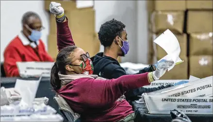  ?? JOHN SPINK / JOHN. SPINK@ AJC. COM ?? Scores of Fulton County electionwo­rkerswerew­orking long hours Thursday in the effort to finish counting ballots at State FarmArena. Fulton elections head Richard Barron said 145,748 absentee- by- mail ballots have been processed.