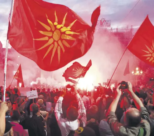  ??  ?? Opponents of the name deal between Greece and Macedonia gathered outside the parliament, Skopje, June 23.