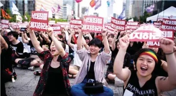  ??  ?? File photo shows protesters holding placards reading ‘Abolish punishment for abortion’ as they protest South Korean abortion laws in Gwanghwamu­n plaza in Seoul.