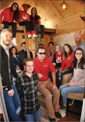  ?? PHOTO COURTESY OF JESSICA A. MARZELLA PHOTOGRAPH­Y ?? How many people can you fit inside the tiny house? STEAM students and club advisers cram into the structure for a group photo.